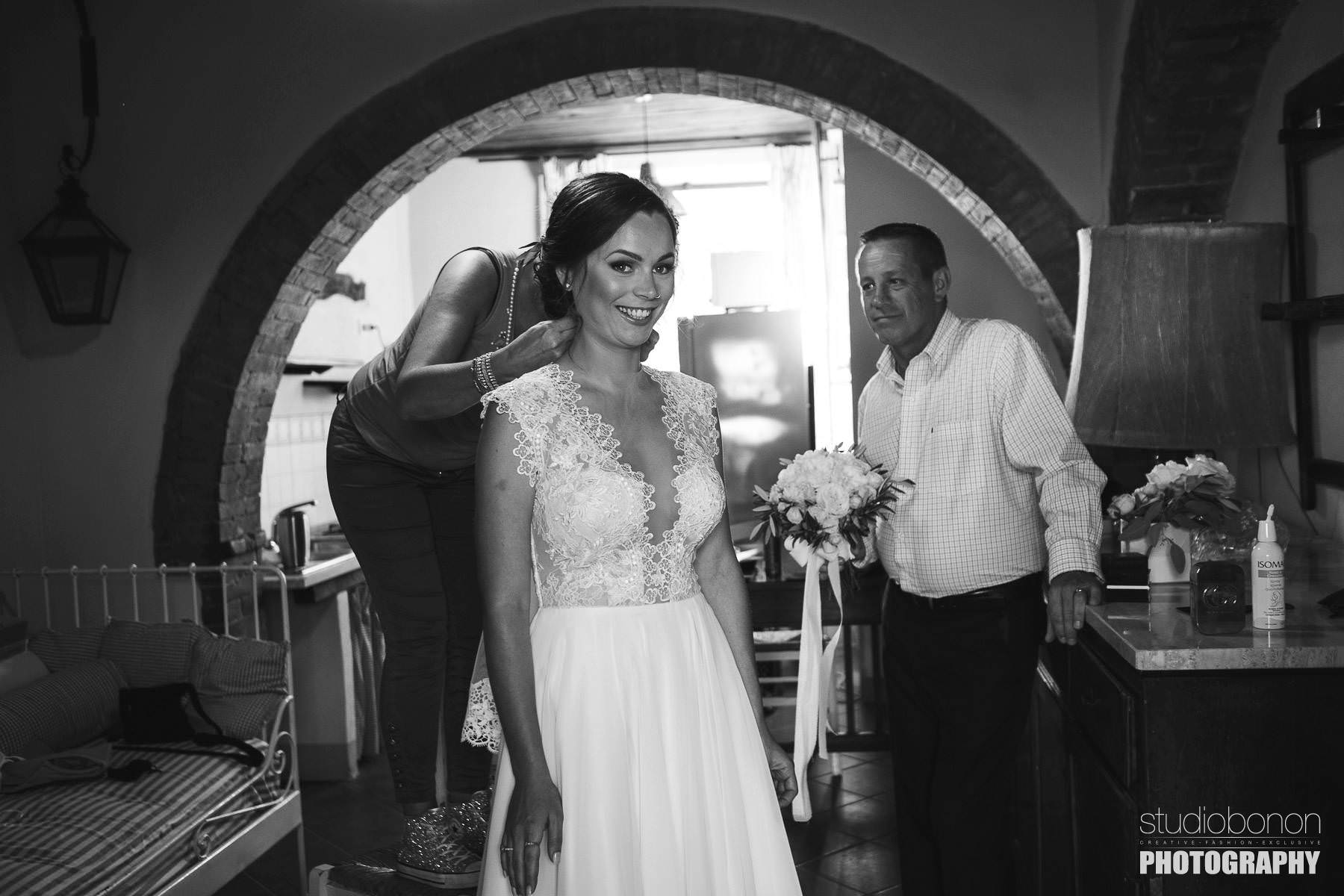 Bride is almost ready to leave for the outdoor ceremony. Rustic Tuscany countryside intimate wedding at Tenuta di Papena and Roofless Abbey of San Galagano
