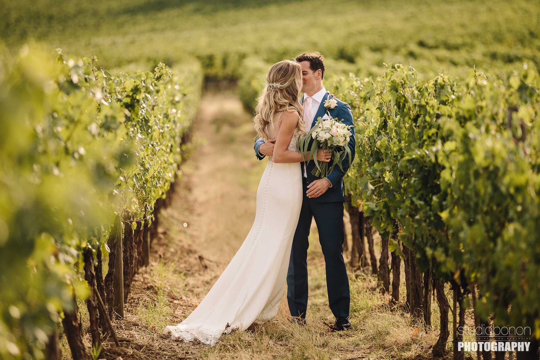 Bride and groom wedding photo into the vineyard. Tuscany countryside destination wedding