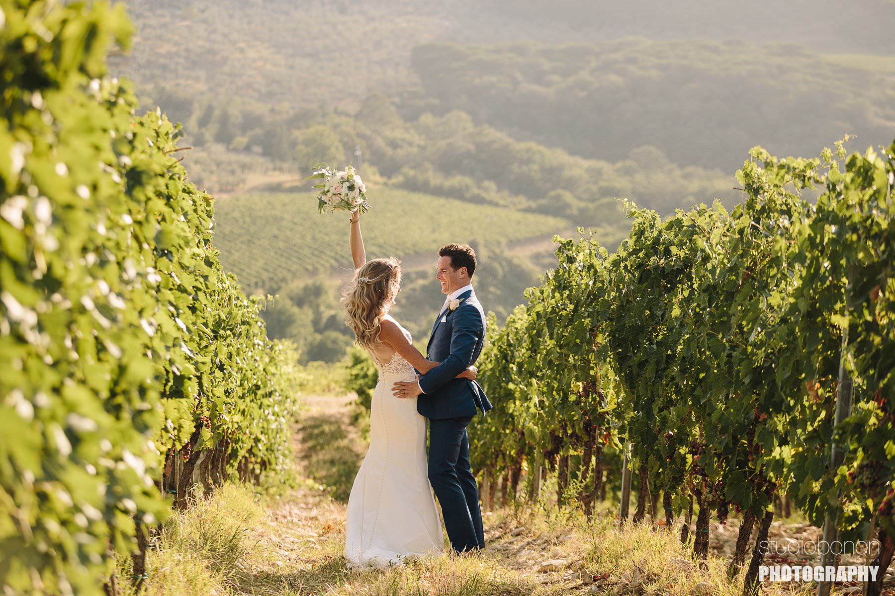 Bride and groom are sharing some lovely moment in a Tuscan vineyard into the countryside of Chianti