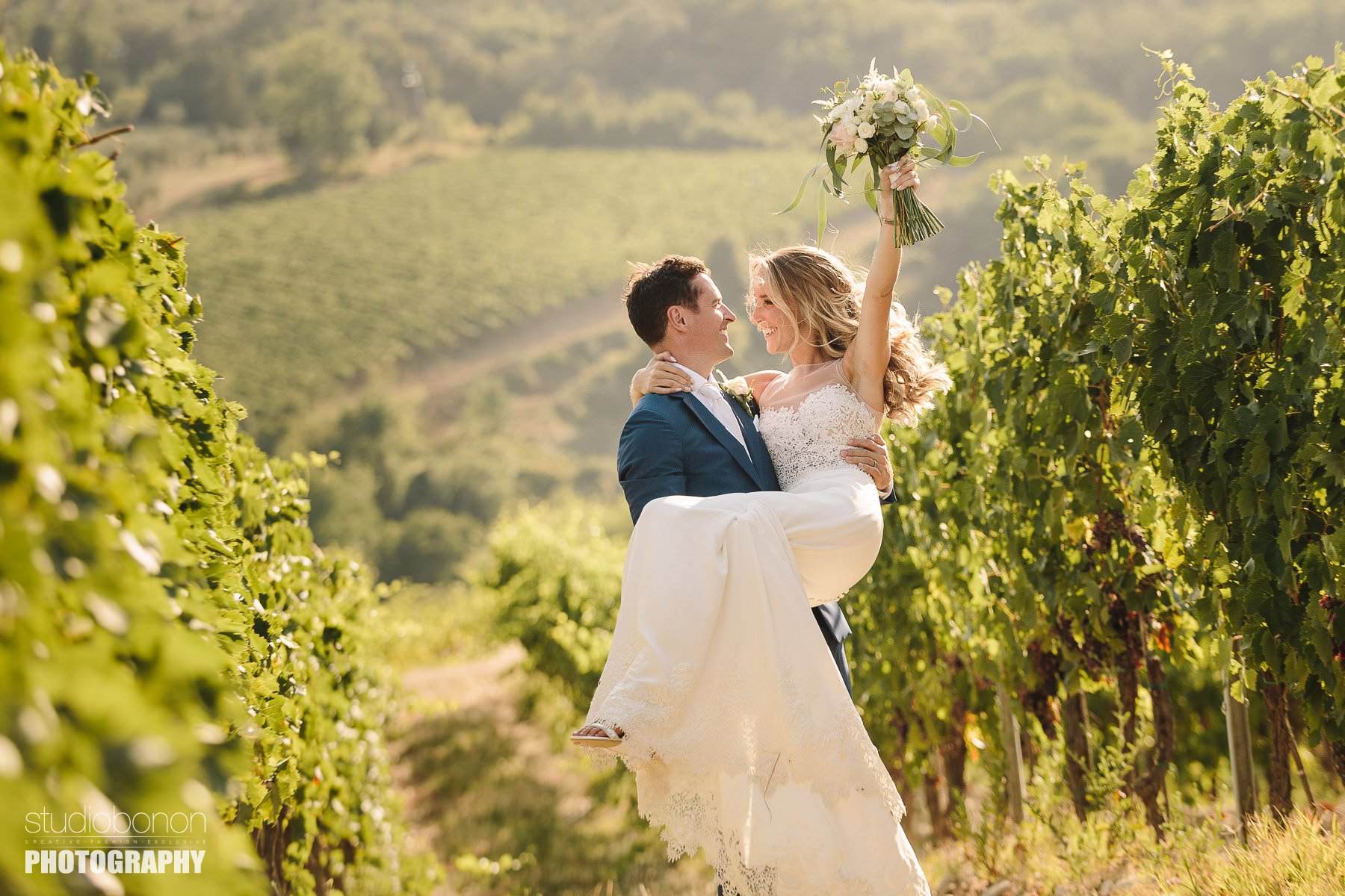 Bride and groom are sharing some lovely moment in a Tuscan vineyard into the countryside of Chianti near Villa Pisignano